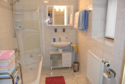 a small bathroom with a sink and a shower at Ferienwohnung Am Untermarkt in Mittenwald