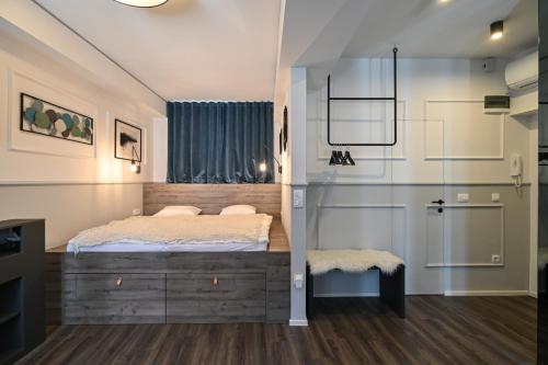 a bedroom with a bed and a glass wall at Strict city apartments in Ljubljana