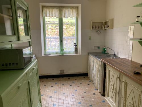 a kitchen with a sink and a window at Treignac Tourelles in Treignac