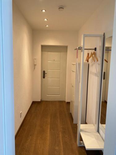 a hallway with a white door and a mirror at Julias Ferienwohnung in Wetzlar