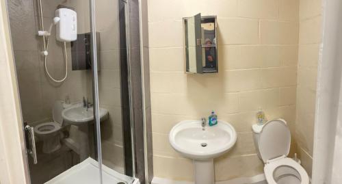 a bathroom with a shower and a toilet and a sink at Jetstream in Boston