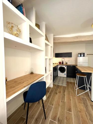 une cuisine avec une table et une chaise bleue dans l'établissement Nuit bleue - tout Grasse à pied !, à Grasse