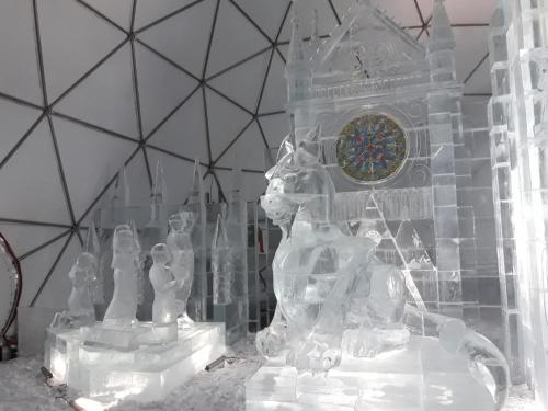 a group of ice sculptures in front of a clock at Liptovský mlyn in Bešeňová