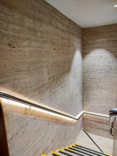 a room with a wall with a chair and a staircase at Ramada by Wyndham Brasilia Alvorada in Brasilia