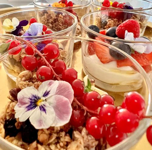 four plastic containers filled with fruit and nuts and yogurt at Villa Utsikten in Tofte