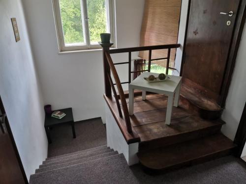 a stairway with a table and a window at VilaEva Adršpach Broumovsko in Ruprechtice