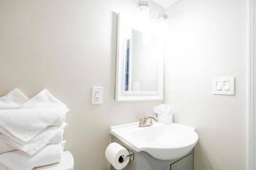 a white bathroom with a sink and a mirror at 300 Tenth in Myrtle Beach
