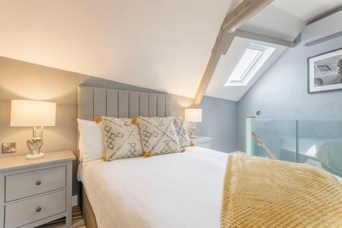 a bedroom with a large white bed with a window at The Old School Room - The Lace Market in Nottingham
