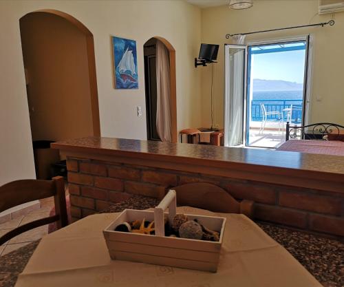 a living room with a counter with a box on a table at Prapas Apartments in Agia Pelagia