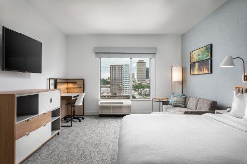 a hotel room with a bed and a desk at TownePlace Suites by Marriott Nashville Midtown in Nashville