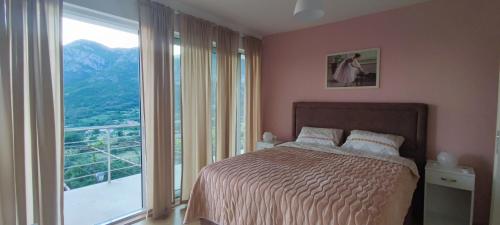 a bedroom with a bed and a large window at DIKA Apartment in Bar