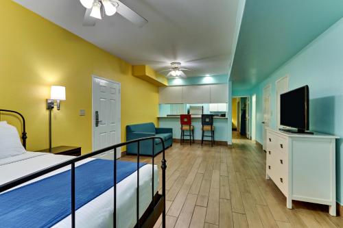 a hotel room with a bed and a television at Island Hotel Port Aransas in Port Aransas