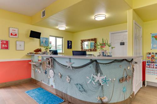 a room with a bar in a room with yellow walls at Island Hotel Port Aransas in Port Aransas