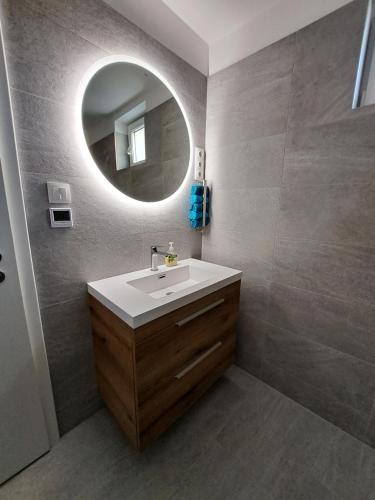 a bathroom with a sink and a mirror at Villa Field6 in Révfülöp