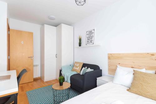 a bedroom with a bed and a chair in a room at El Capricho Terrassa. in Terrassa