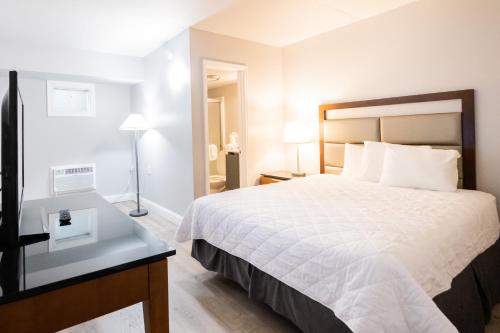 a hotel room with a bed and a desk at Aventura on the Ocean in Myrtle Beach