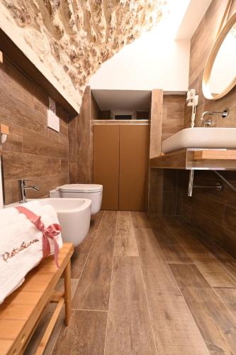 a bathroom with a toilet and a sink at Pietrabianca Apartments San Lorenzo in Manfredonia