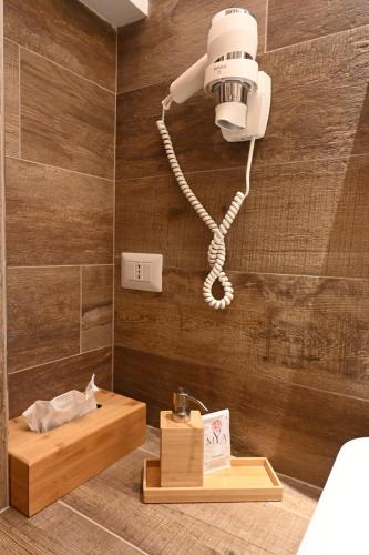 a bathroom with a light on a wall at Pietrabianca Apartments San Lorenzo in Manfredonia