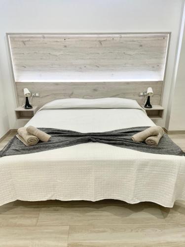 a bedroom with a large bed with two towels on it at ISLAND SUITES in Arona