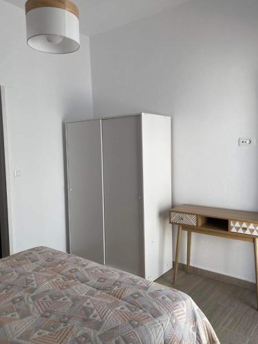 a bedroom with a wardrobe and a bed and a table at Marina's House in Triovasálos