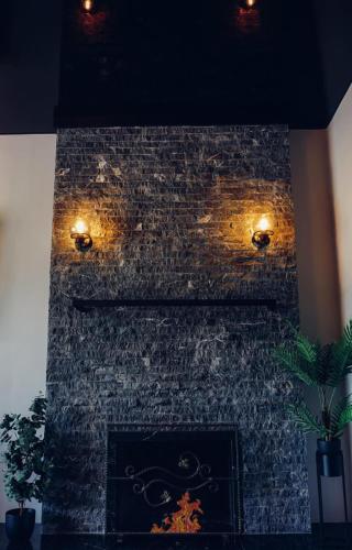a brick fireplace with lights on top of it at Holiday Home in Stepantsminda