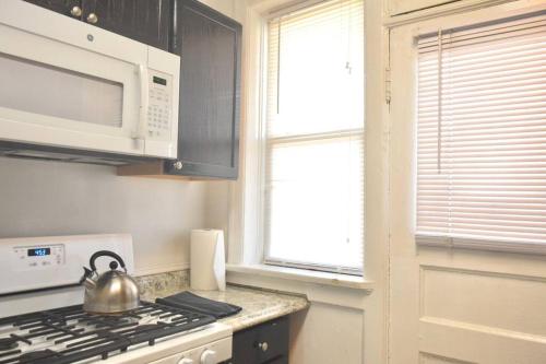 a kitchen with a tea kettle sitting on the stove at (49.1W) Beautiful Getaway in Saint Louis in Saint Louis