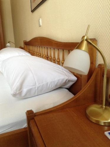 a bedroom with a bed with a desk and a lamp at Tryp by Wyndham Kassel City Centre in Kassel