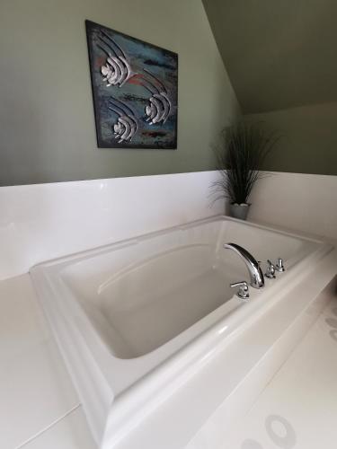 a large white bath tub in a bathroom at Inn on the Harbour and Telegraph House in Port Stanley