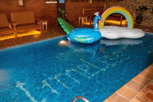 a swimming pool with a pool slide at Timeless Apartment and Bar in Lagos