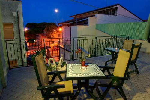 ein Tisch und Stühle auf einem Balkon in der Nacht in der Unterkunft La Casa Del Nonno in Campomarino