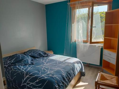 a bedroom with a bed and a window at la champagnolaise in Champagnole