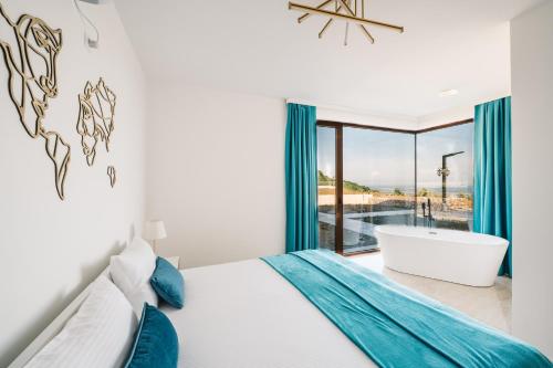 a bedroom with a bed and a tub and a window at Vila katune 2022 in Ulcinj