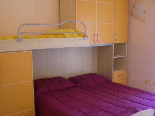 1 dormitorio con 2 literas con sábanas moradas en Villa Solare, en Marina di Noto