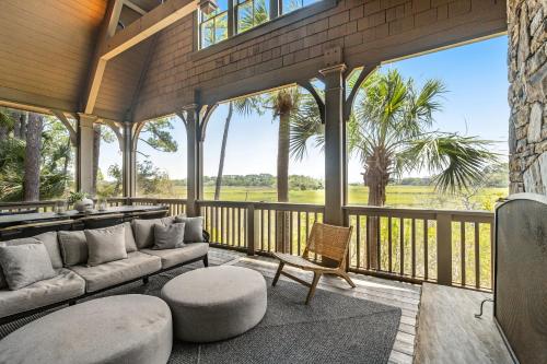 a screened in porch with a couch and a chair at Club Cottage 6 in Kiawah Island