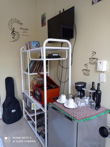a room with a shelf and a table with food at Paraiso Hortensia Ecolodge in Santiago de los Caballeros