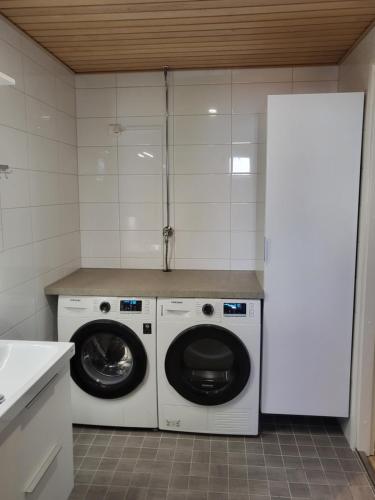 a kitchen with a washing machine and a washer and dryer at Captain's Square in Lahti