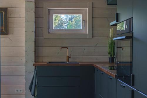 a kitchen with a sink and a window at Odi Resort in Ilmasoo