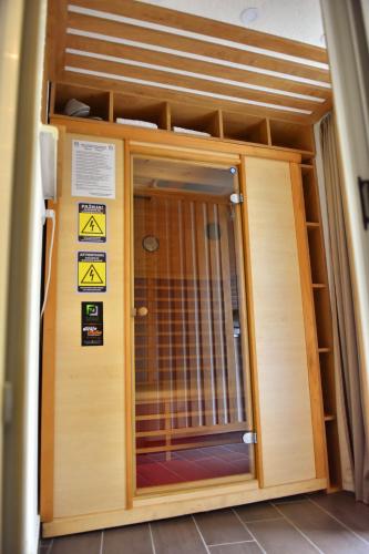 a door of a building with signs on it at Design Apartment PREMIUM SPA LUX 4 STAR "DUBAI" Completely PRIVATE Wellness & Spa FREE INCLUDED Sauna & Jacuzzi & Salt Wall & Fire place & 3D Ceilings & Business WiFi & NETFLIX & Keyless code entry & FULL SMART APP & SECURE 2 Parking place in Ćuprija