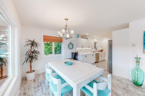 a white dining room with a white table and chairs at Brooks Lake House in Christina