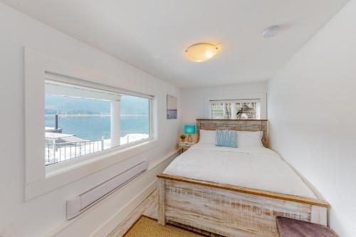 a bedroom with a bed and a large window at Brooks Lake House in Christina