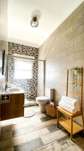 a bathroom with a tub and a toilet and a sink at Marzia Boutique Home in Olhão
