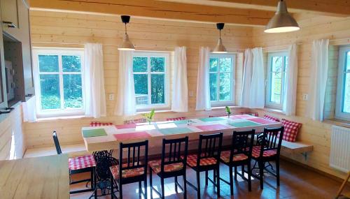 a kitchen with a large island in a room with windows at Malá Hofmanka, horská chalupa na samotě, Krkonoše in Vítkovice