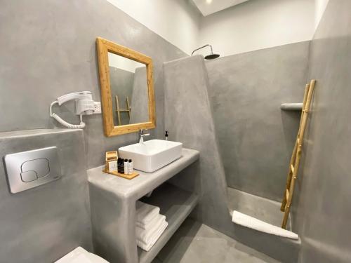 a bathroom with a sink and a mirror at Lyra Seafront Apartment , Paroikia Town Center in Parikia