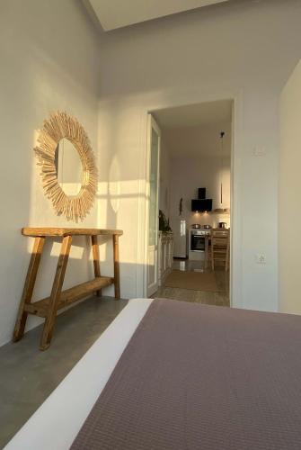 a mirror sitting on top of a wooden table in a room at Lyra Seafront Apartment , Paroikia Town Center in Parikia