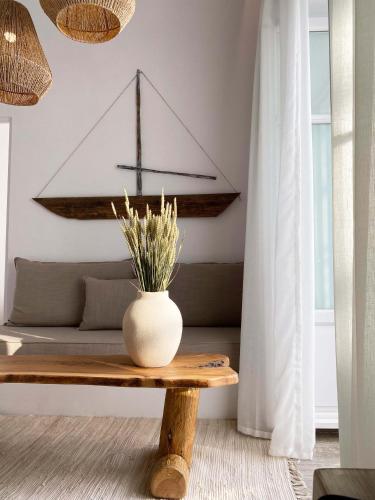 a living room with a table and a couch at Lyra Seafront Apartment , Paroikia Town Center in Parikia