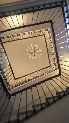 a ceiling with a clock in a room at Ca Meison in Cannobio