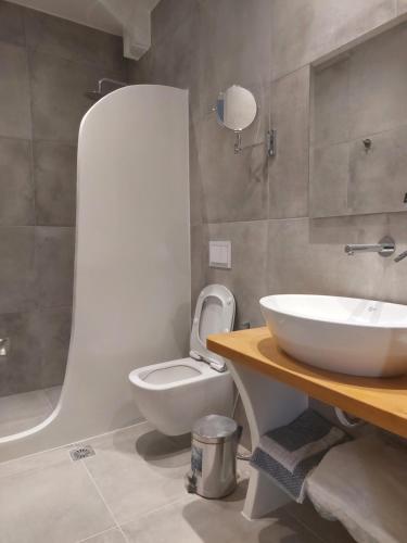 a bathroom with a white toilet and a sink at Elite Suites Naxos in Naxos Chora