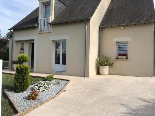 a home with a driveway and a house at Le Hameau du moulin a vent in Saint-Avertin