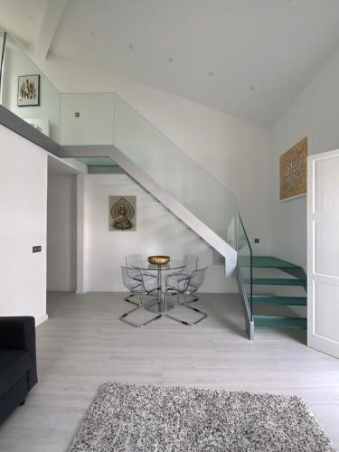 a living room with a table and a staircase at Luxury Loft Apartment in Ribeira Grande