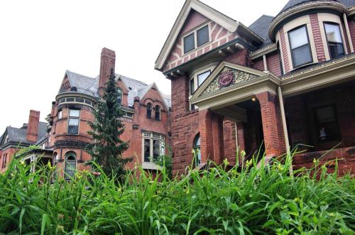 a large red brick house with a turret at The Inn on Ferry Street in Detroit